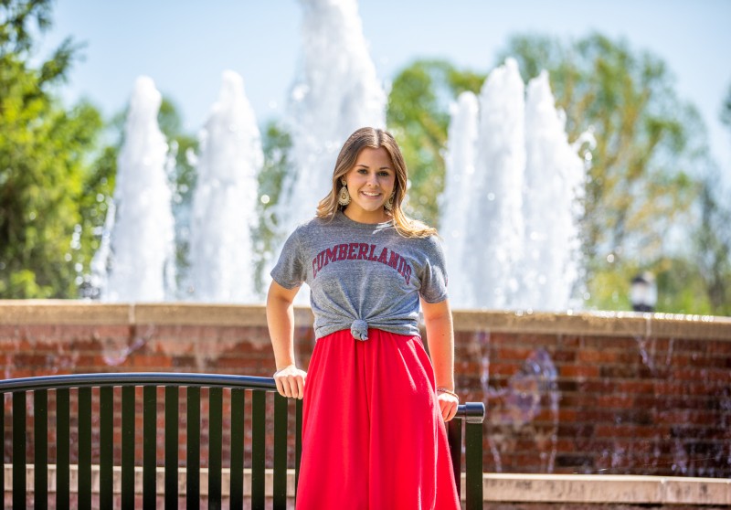 A Cumberlands student stands in front of the fountain on campus.